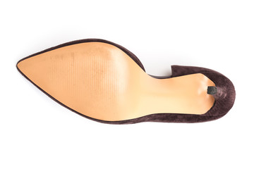 Sole of stylish classic suede women's leather shoes with medium high heels on an isolated white...