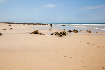 Old couple hiking along the beach of Cape St Francis