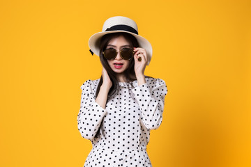 Asian woman in summer casual clothes.She smiling and  happy shopping. she  lovely attractive shine on  yellow background.Summer Surprise Sale  concept.