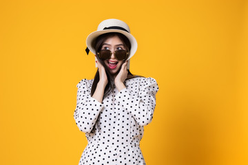 Asian woman in summer casual clothes.She smiling and  happy shopping. she  lovely attractive shine on  yellow background.Summer Surprise Sale  concept.