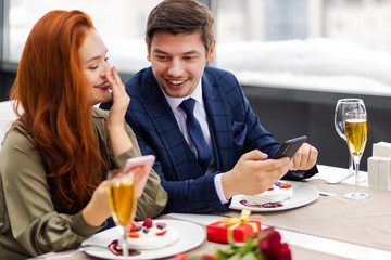 beautiful caucasian couple enjoy to be together, attractive lady and handsome guy spend time together in restaurant, they have dinner. love. marriage, dating, couple concept