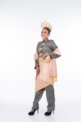 A beautiful Malaysian traditional female dancer wearing traditional dance outfit. Full length portrait isolated in white.