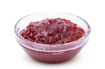 raspberry jam in transparent bowl isolated on white background