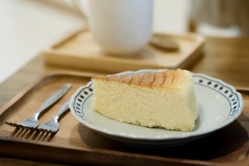 Soft cake on wood plate in coffee cafe