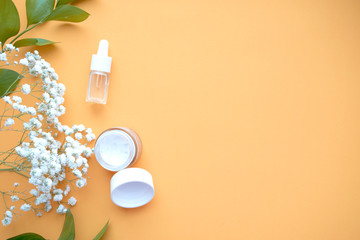 Cosmetic background. Organic cosmetics with coconut on a yellow background. Top  View. Copy space.