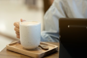 A girl drinking hot milk tea in cafe