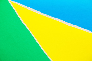 Blue, green and yellow torn and ripped cardboard paper texture background. Copy space for text...