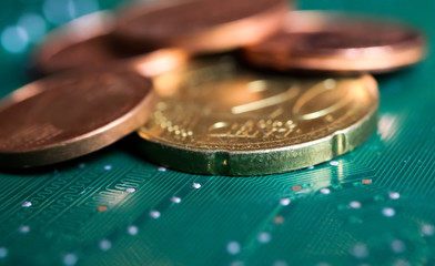 Makro close up of isolated blurred pile euro cent coins on green motherboard