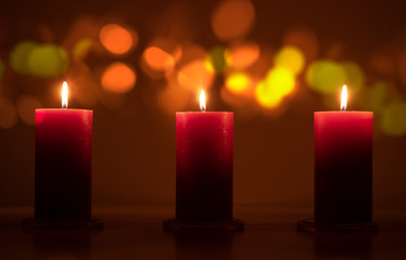 Red candles flame at night closeup