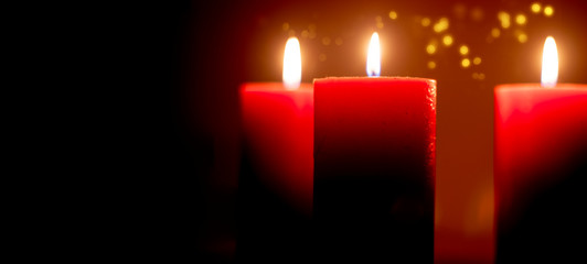 Red candles flame at night closeup