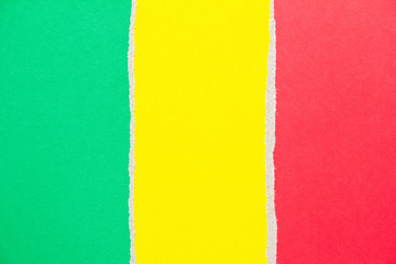 Green, red and yellow torn cardboard paper texture background. Copy space for text message.
