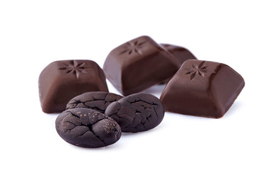 Cacao beans and dark chocolate on white background