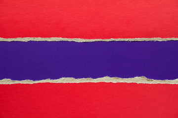Red and purple blue torn and ripped sheet of cardboard paper texture background. Can be used for...