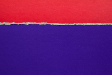 Torn red cardboard on blue paper texture background. Copy space for text message.
