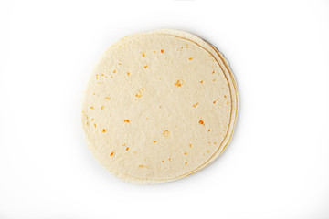 Tortilla on a white isolated background. Corn tortilla or simply tortilla is a type of thin unleavened bread made from Hominy.