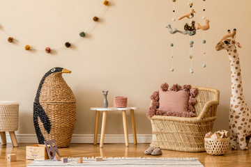 Stylish beige scandinavian interior of child room with natural toys, hanging decoration, design...