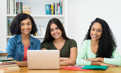 Portrait of group of latin american female students at computer