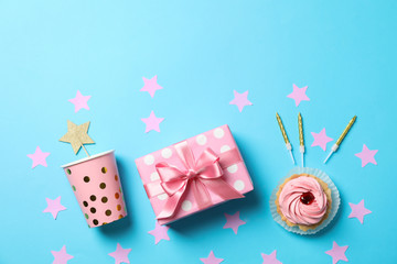 Composition with gift box and birthday accessories on blue background, space for text