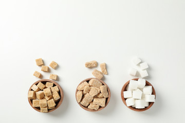 Bowls with sugar on white background, top view