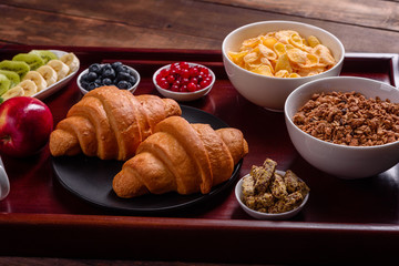 Delicious breakfast with fresh croissants and ripe berries
