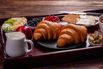 Delicious breakfast with fresh croissants and ripe berries