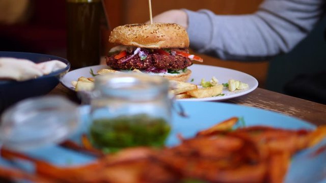 Eating Healthy Vegan Burger With French Fries . Closeup.