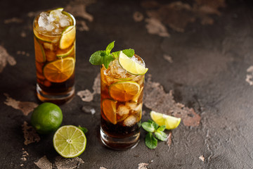 Cuba Libre with brown rum, cola, mint and lime. Cuba Libre or long island iced tea cocktail with...