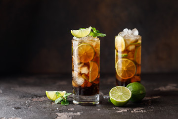 Cuba Libre with brown rum, cola, mint and lime. Cuba Libre or long island iced tea cocktail with...