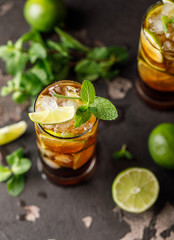 Cuba Libre with brown rum, cola, mint and lime. Cuba Libre or long island iced tea cocktail with strong drinks