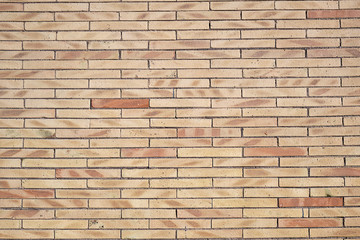Background from a wall of beige clinker bricks