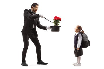 Magician making a magic trick with roses and an excited schoolgirl watching