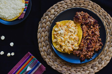 Calentado and huevos pericos con arepa is a traditional breakfast from Colombia made with maize, eggs, rice and black beans
