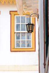 Facade of old houses in colonial architecture and lighting lantern