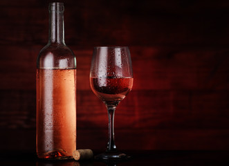 open wine bottle with goblet and cork