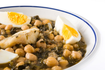 Chickpea stew with spinach and cod or potaje de vigilia isolated on white background