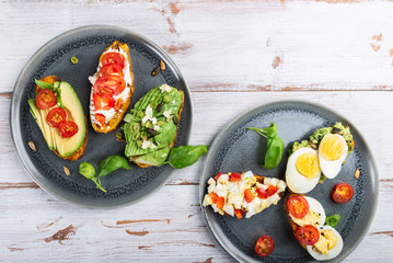 Sweet potato toasts with avocado, eggs, tomatoes and sesame seeds
