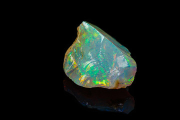 macro mineral stone rare and beautiful opals on a black background