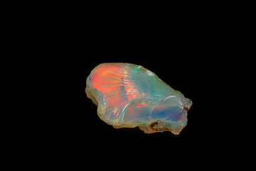 macro mineral stone rare and beautiful opals on a black background