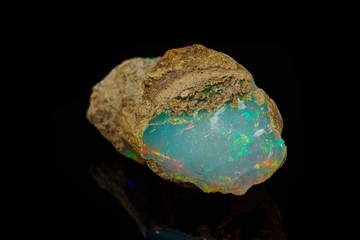 macro mineral stone rare and beautiful opals on a black background