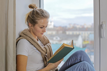 Portrait of a european beautiful girl who reads a book