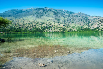 Exciting view to crystal turquoise green lake near mountain. Greece, Island Crete.