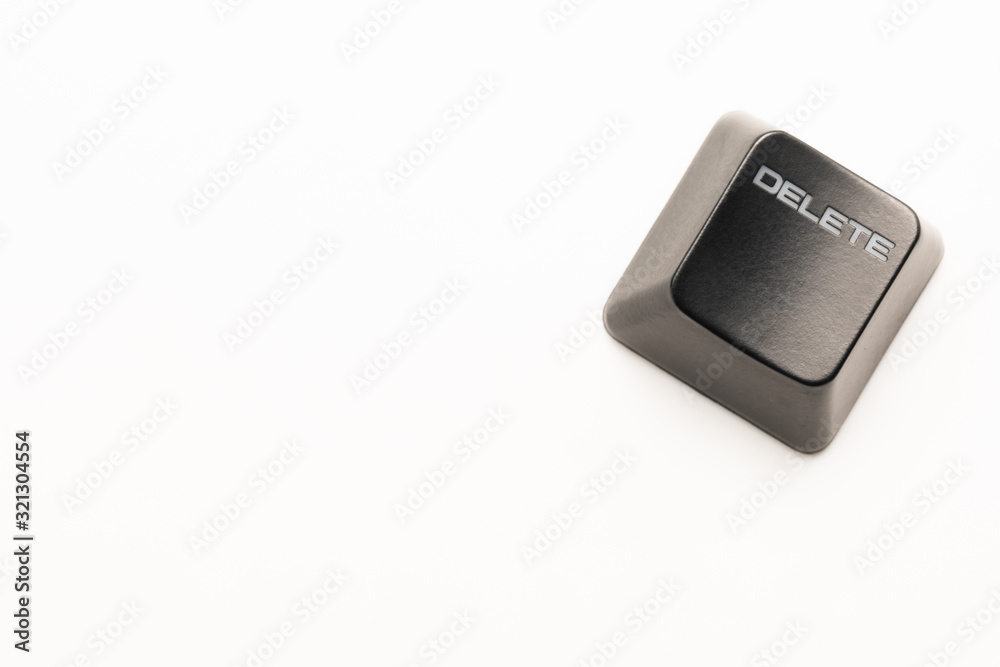 Fototapete black keyboard button with a white inscription Delete in the corner on a white background