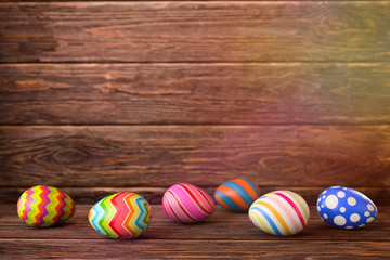 Fototapeta na wymiar Easter eggs on wooden background. 3D rendering illustration.