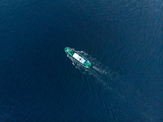 Oil chemical tanker sails blue sea fog. Aerial top view