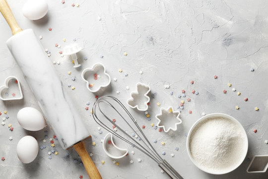 Flat Lay Or Overhead View Of Baking Tools And Ingredients In Pastel Tones On A Gray Board