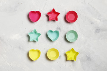 Colorful silicone cupcake cases on a gray background.