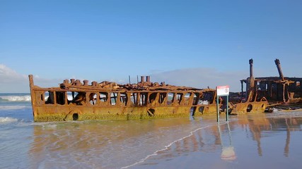 HD slow panning left to right locked off motion of the abandoned SS Maheno shipwreck which washed ashore on the coastline of Fraser Island in 1935 by a cyclone and left to rust,QLD,Australia 