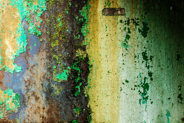Background metal wall with peeling green paint