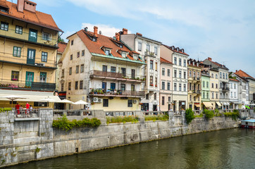 Fototapeta na wymiar Panorama of old town Ljubljana, Slovenia, with numerous bars and restaurants at waterfront of Ljubljanica river.