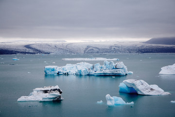 Icebergs in Jokulsarlon lagoon beneath Breidamerkurjokull glacier Sudhurland, Iceland. Place for text or advertising